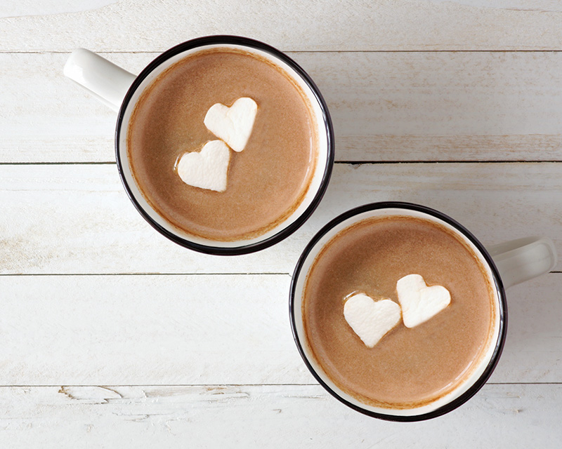 Cups of hot chocolate with marshmallow hearts