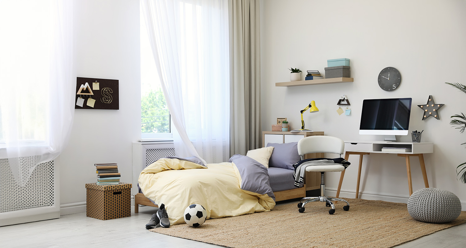 Teenager's bedroom with soccer ball, desk, unmade bed. Therapy for teens in Madison Wisconsin