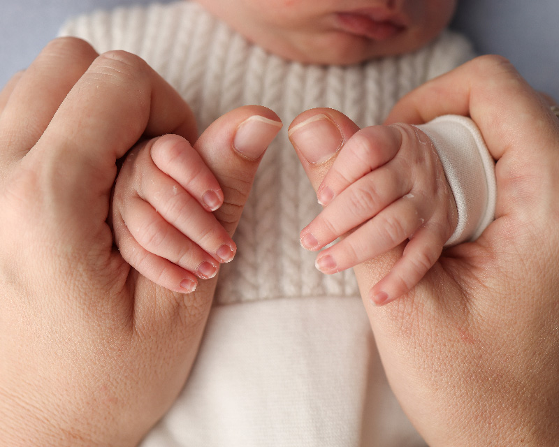 Newborn baby with mother's hands