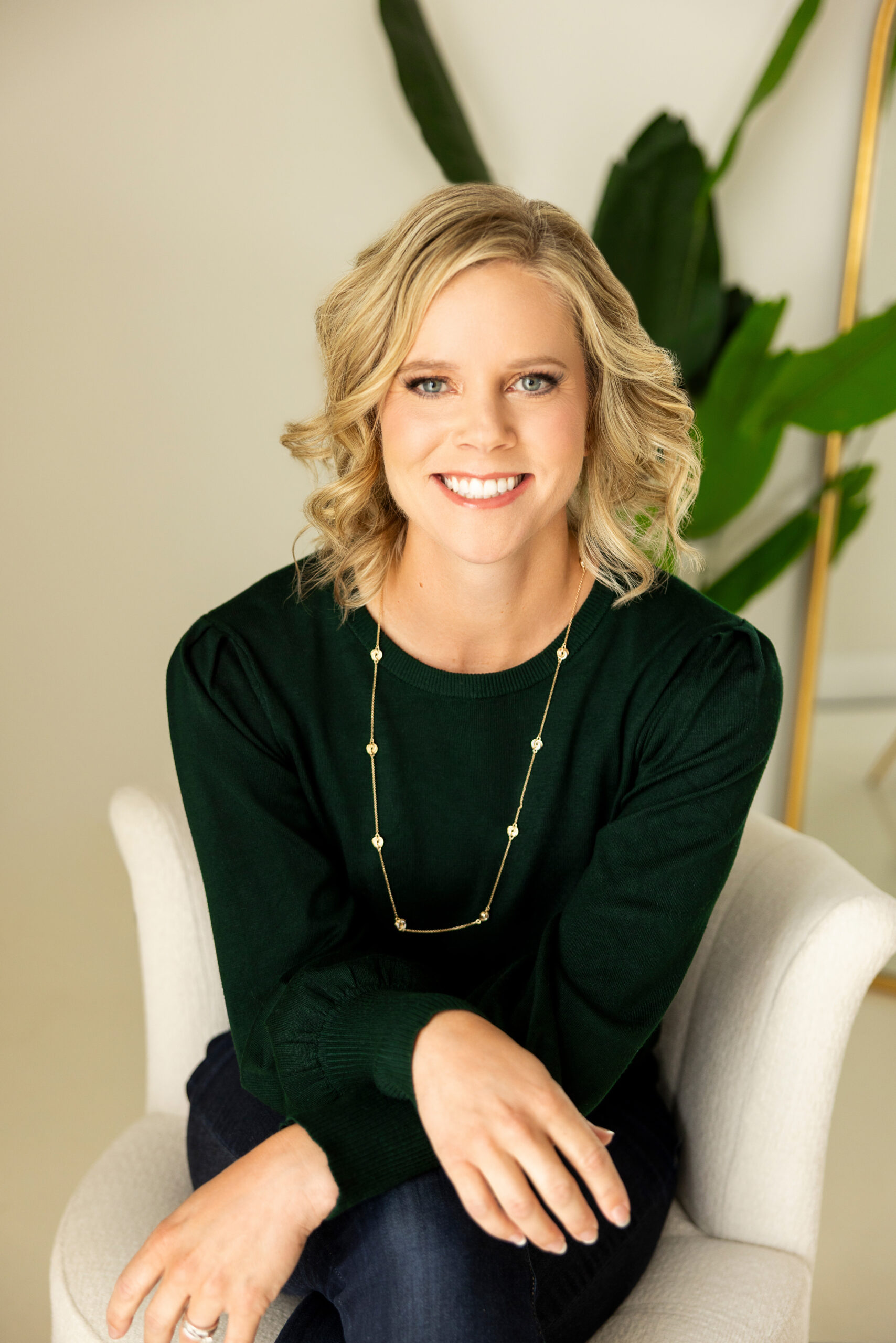 Amy Racki, therapist in Madison WI, smiling while seated in a chair