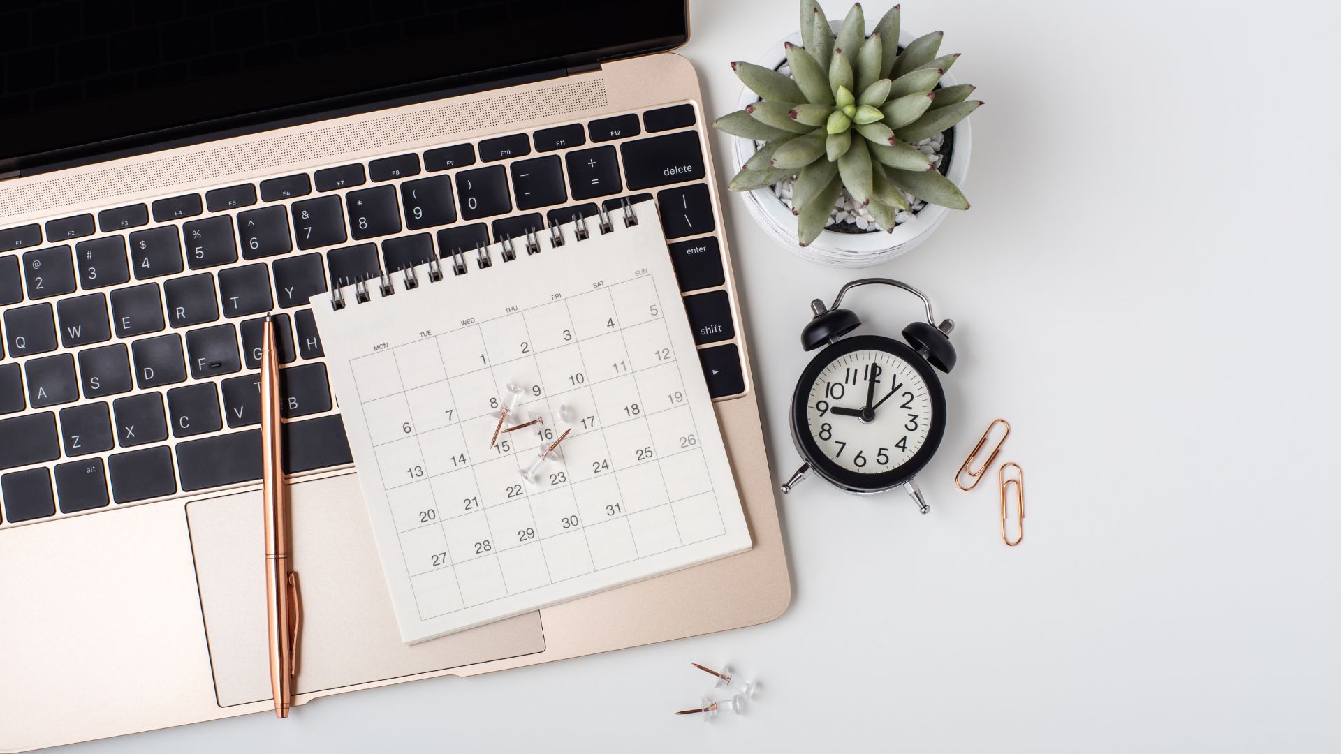 calendar and clock on desk with laptop and pen showing planning and time management for fall routine tips Madison WI