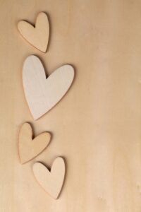 wooden hearts representing the growth of HEART Counseling’s team and trauma-informed therapy in Madison WI