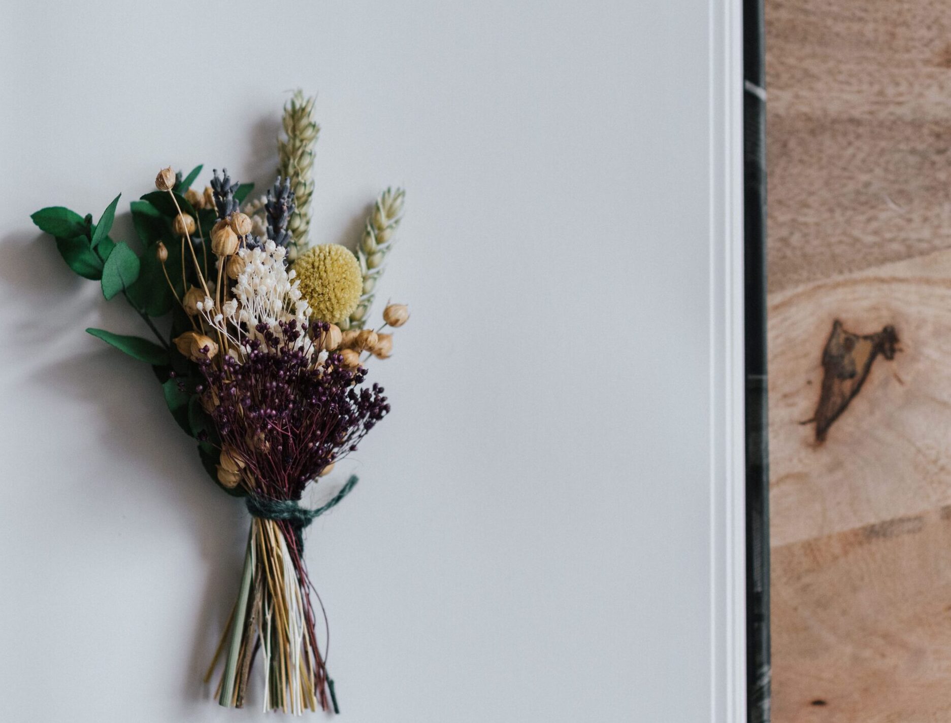 Dried flowers resting on an open journal representing grief counseling and healing after loss in Madison, WI.