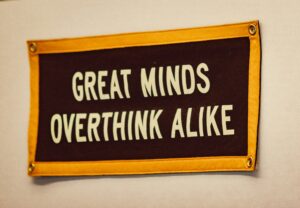Anxiety therapist near me image of a sign reading “Great Minds Overthink Alike,” representing anxious overthinking and worry.