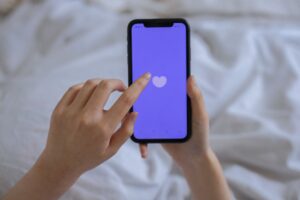 Person using a smartphone illustrating digital connection, social media, and modern loneliness.