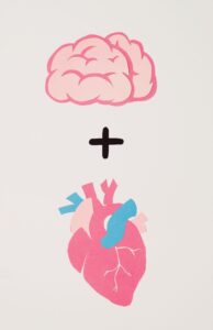 Pink brain and anatomical heart illustration representing the connection between mental, physical, and emotional health