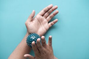 Hands holding a textured sensory ball as a grounding activity that may support nervous system regulation.