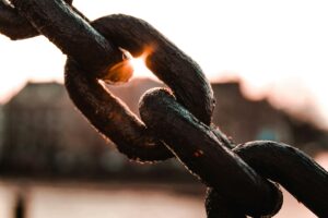 Broken metal chain illuminated by sunlight, representing autonomy and healing through relationship trauma therapy in Madison.