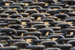 Interconnected metal chains representing patterns of control and emotional abuse explored in relationship trauma therapy in Madison.